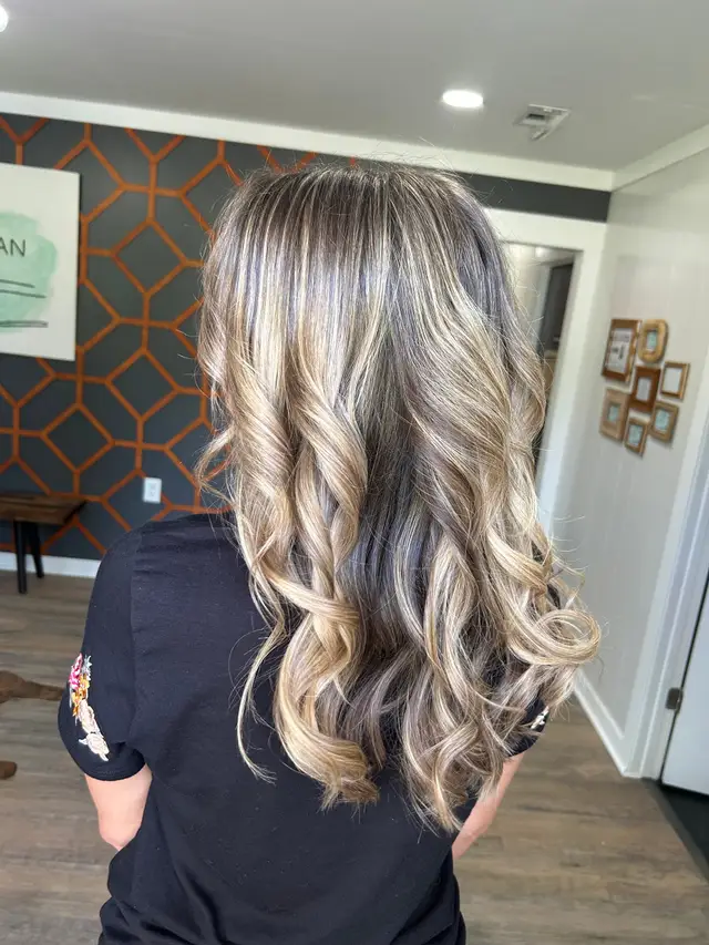 Close-up of curled balayage highlights showing dimensional color placement