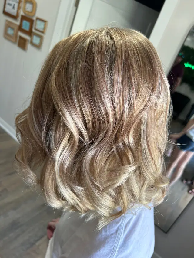 Blonde balayage on a shoulder-length bob with soft dimensional highlights