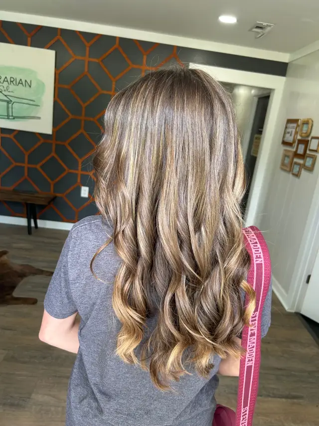 Caramel and honey blonde balayage waves with warm dimensional tones
