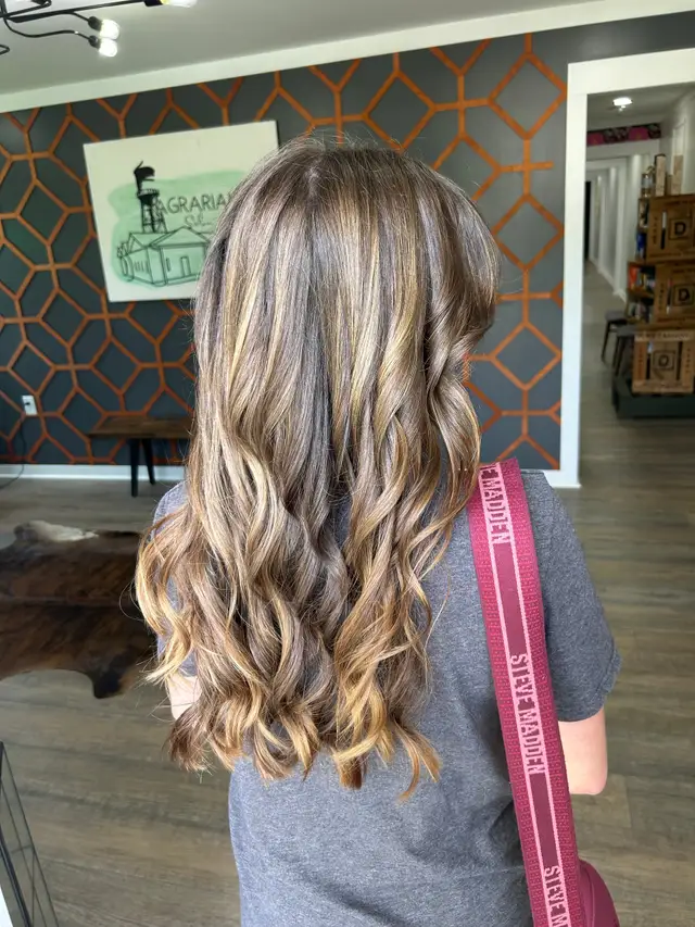 Soft caramel blonde balayage with loose beachy waves